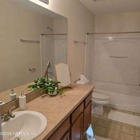 a bathroom with a sink a toilet and mirror