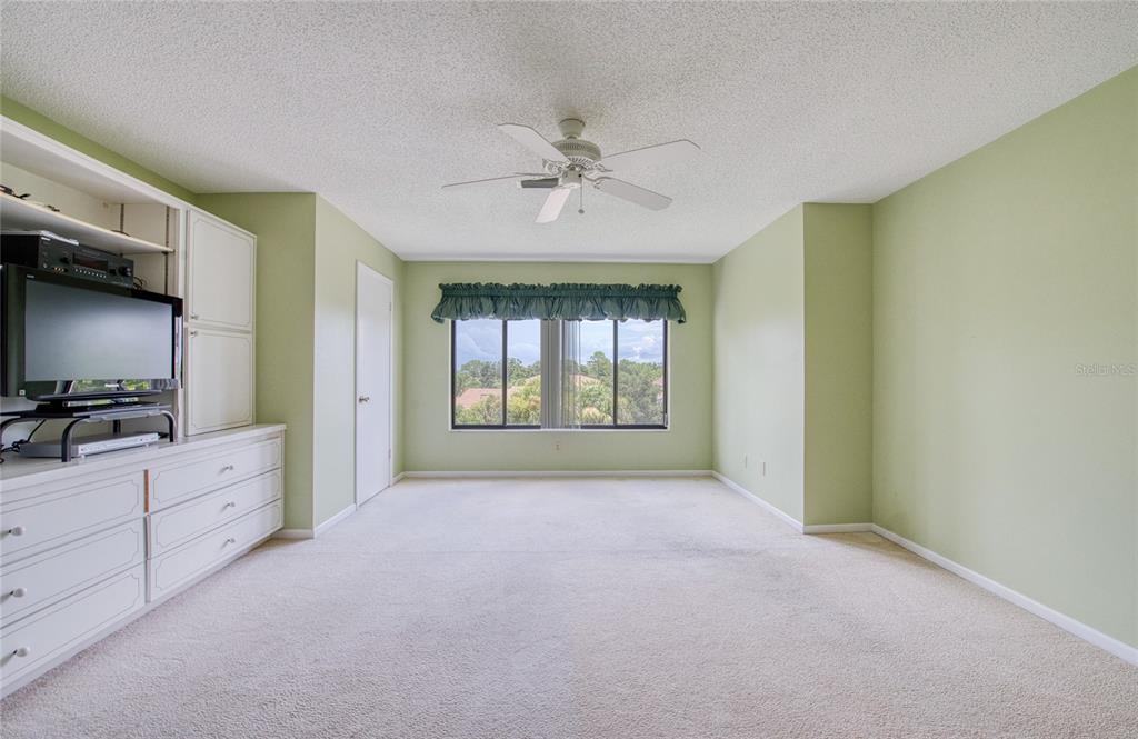 700 Starkey Road, Unit 1145 Largo, FL 33771 - Photo 21 of 63 a view of an empty room with a window and a flat screen tv