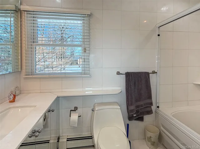 a bathroom with a sink a toilet and bathtub