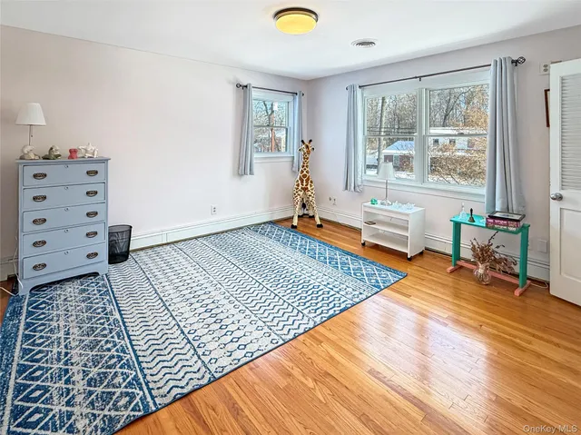 a bedroom with furniture and a window