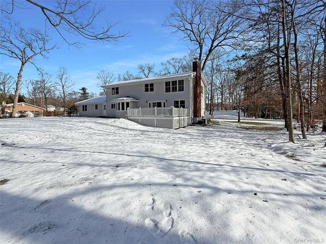 a view of a house with snow on the road