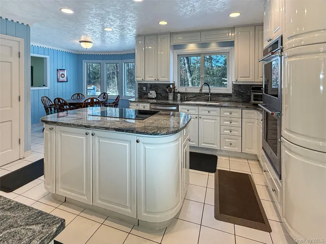 a kitchen with a sink cabinets and window