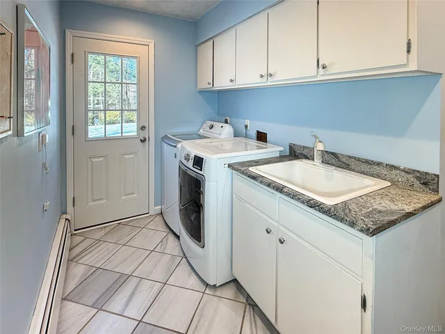 a utility room with sink dryer and washer