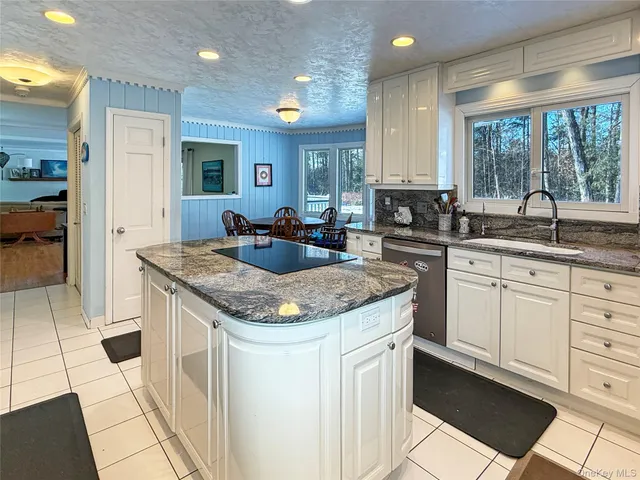 a kitchen with stainless steel appliances granite countertop a sink stove and cabinets