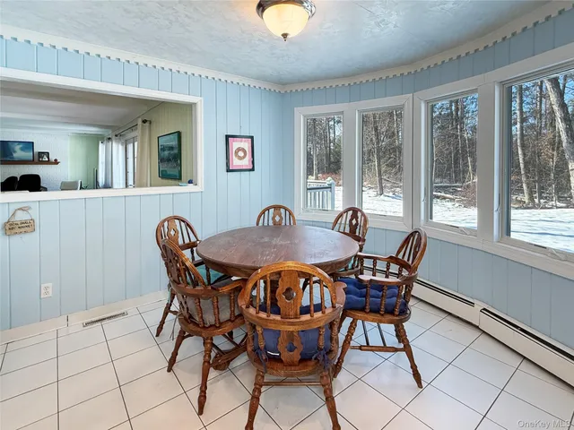 a view of a dining room with furniture and window