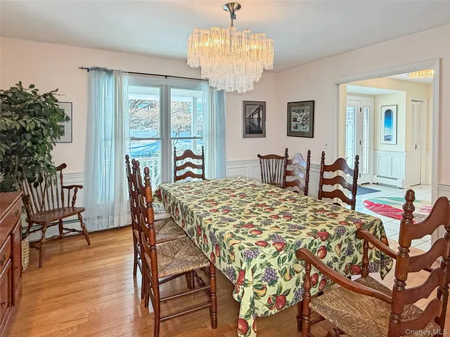 a view of a dining room with furniture wooden floor and chandelier