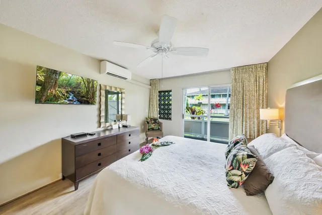 a bedroom with a bed dresser and a window