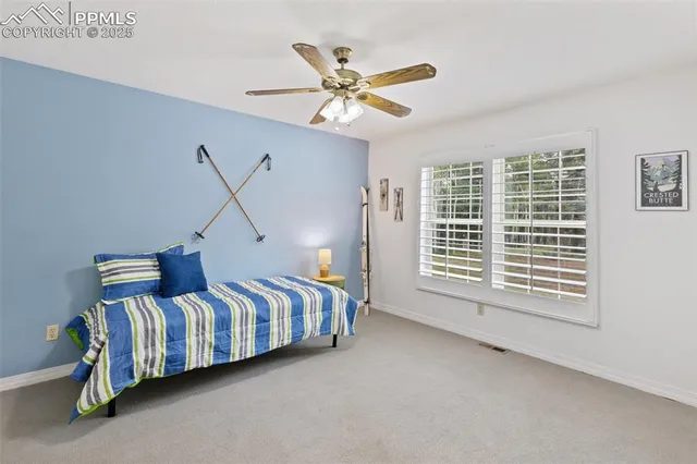 a view of a livingroom with wooden floor and a ceiling fan
