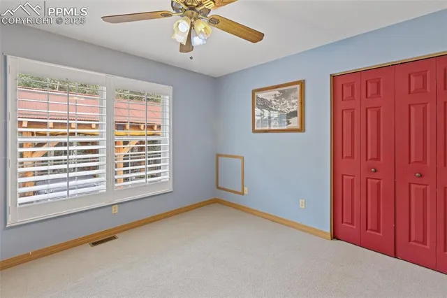 a living room with furniture a flat screen tv and a chandelier