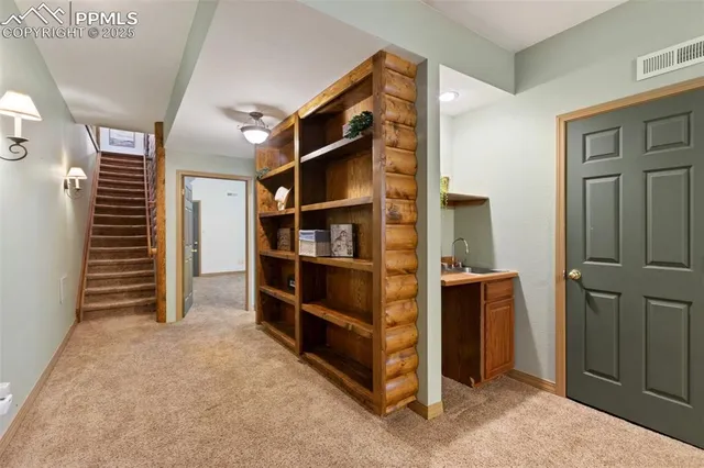 a bathroom with a granite countertop sink a toilet and a mirror