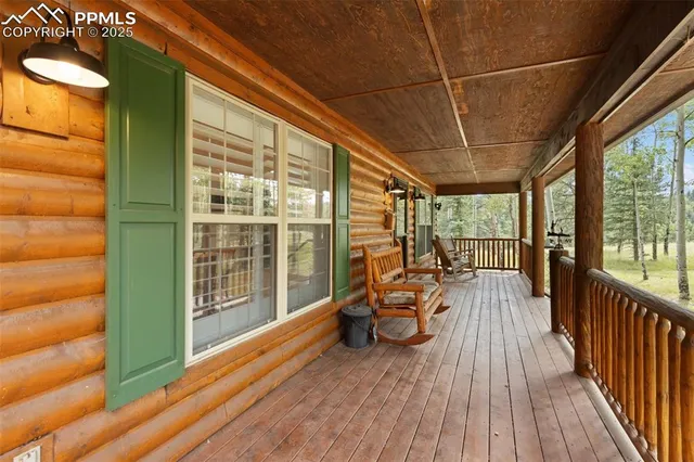 a view of a balcony with chairs and wooden floor