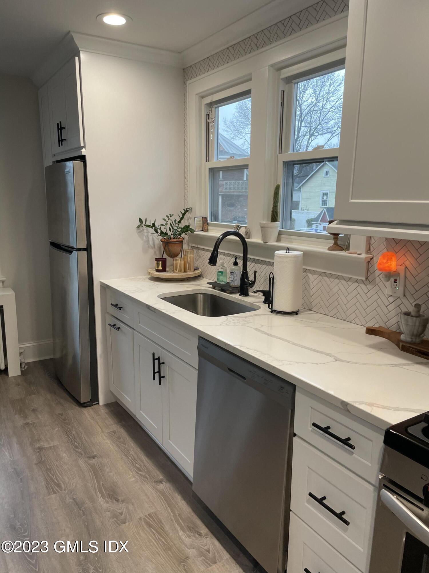 60 Weaver Street, Unit 2 Greenwich, CT 06831 - Photo 7 of 20 a kitchen with stainless steel appliances a sink stove and refrigerator