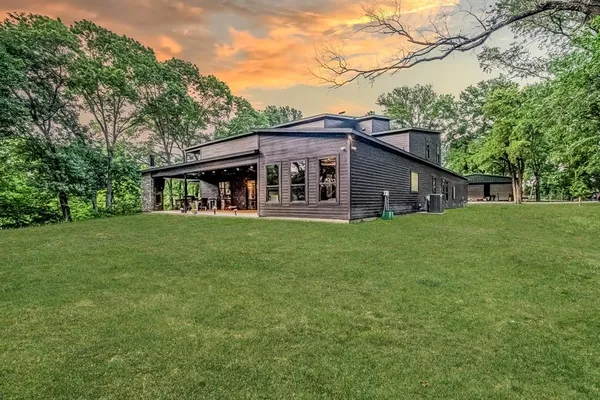 a view of a house with backyard porch and furniture