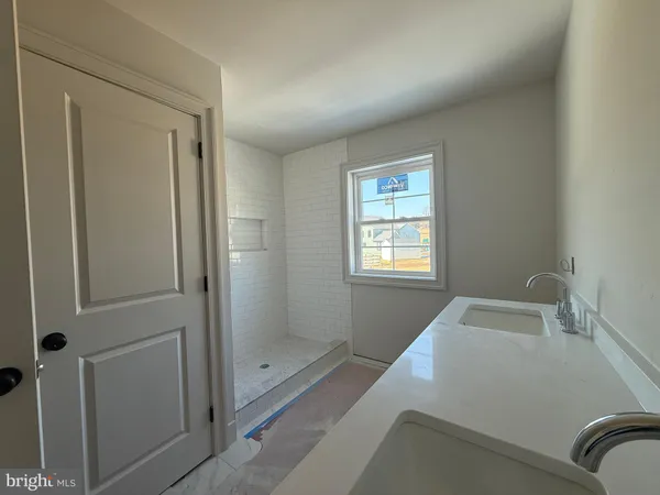 a spacious bathroom with a toilet and a shower