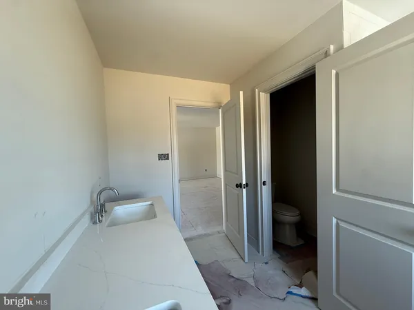a bathroom with a sink toilet and a window