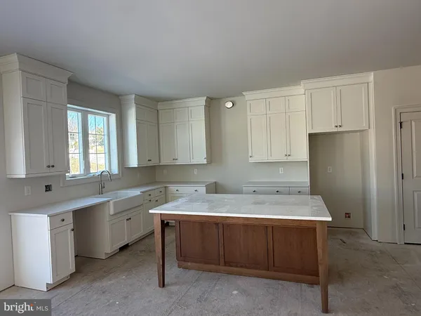 a view of a kitchen with a sink dishwasher and a fireplace