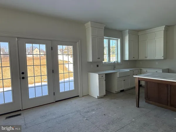 a kitchen with a sink stove and cabinets