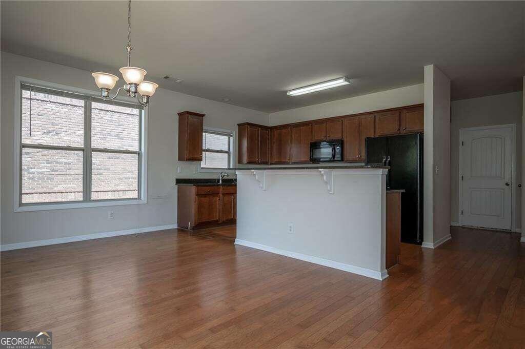 304 Ridge Pointe Drive Athens, GA 30606 - Photo 11 of 50 a kitchen with kitchen island granite countertop a stove top oven a sink and a chandelier