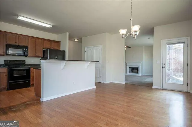 a view of a kitchen with a sink and a refrigerator