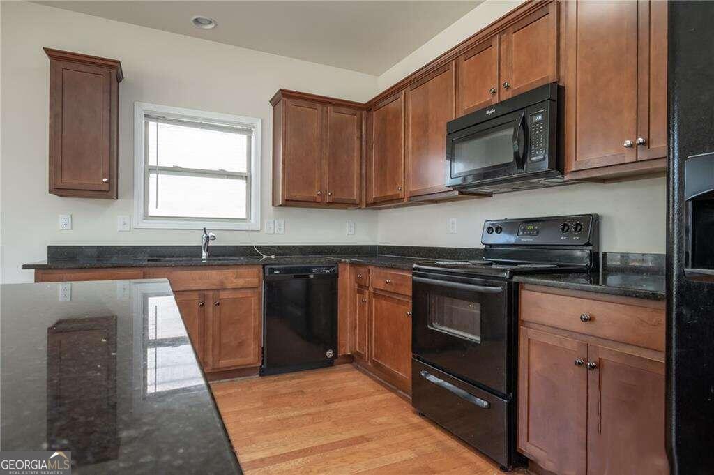 304 Ridge Pointe Drive Athens, GA 30606 - Photo 18 of 50 a kitchen with granite countertop a stove top oven microwave and cabinets