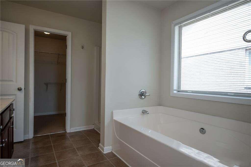 304 Ridge Pointe Drive Athens, GA 30606 - Photo 27 of 50 a bathroom with a bathtub and a shower