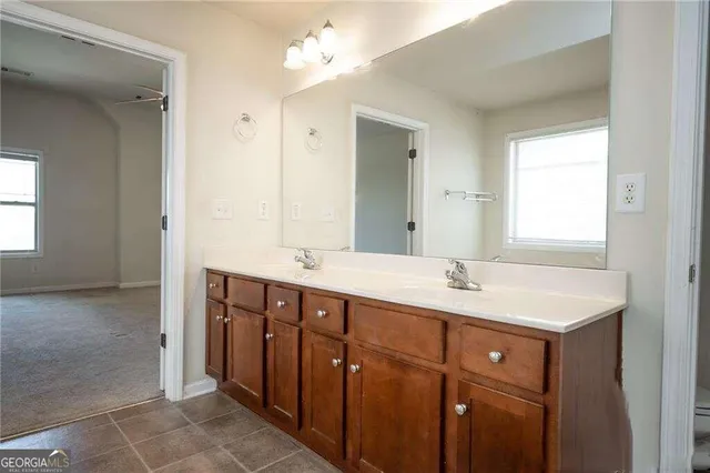a bathroom with a double vanity sink and mirror