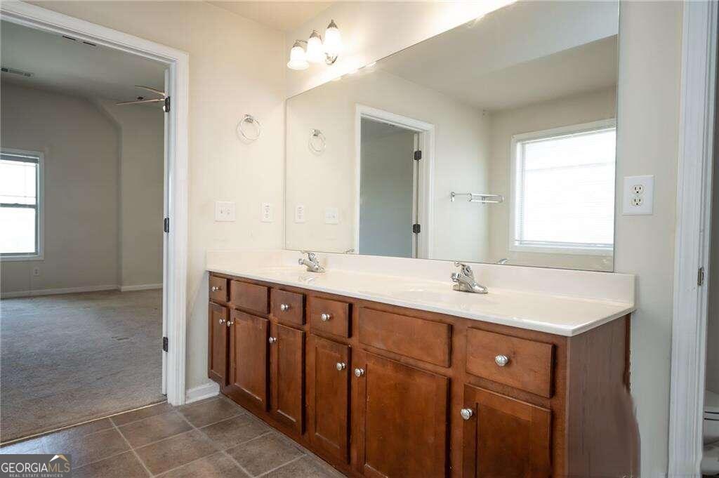 304 Ridge Pointe Drive Athens, GA 30606 - Photo 28 of 50 a bathroom with a double vanity sink and mirror