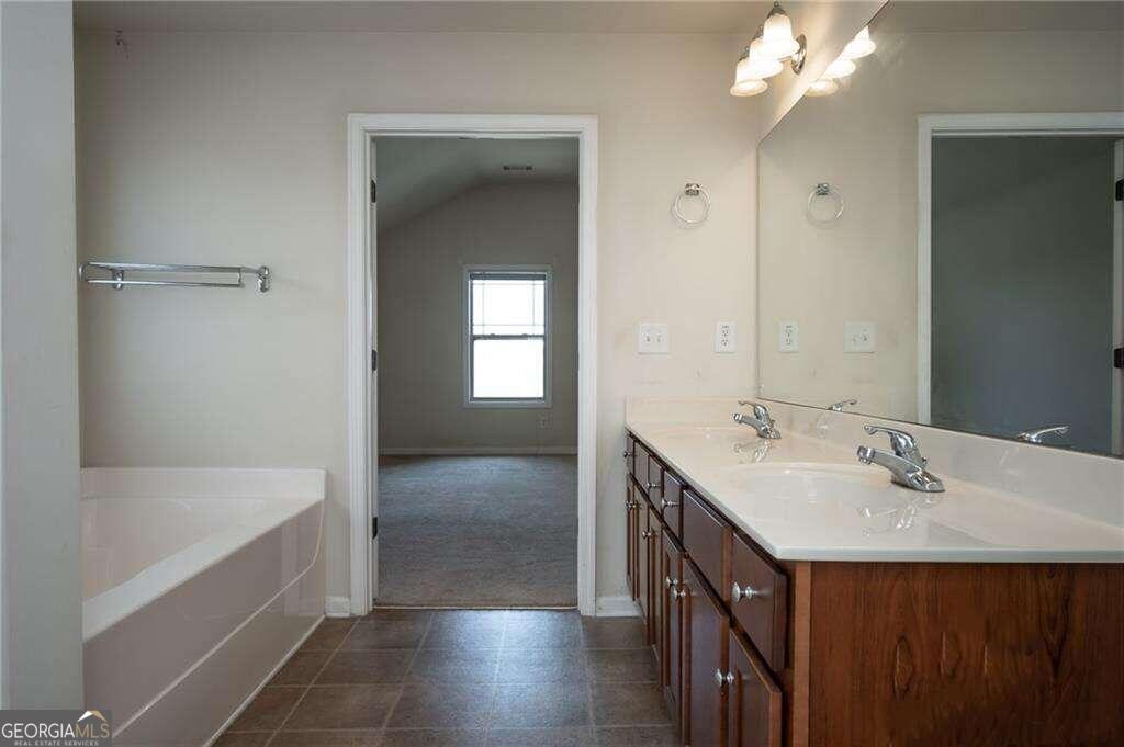 304 Ridge Pointe Drive Athens, GA 30606 - Photo 29 of 50 a bathroom with a sink vanity tub and a mirror