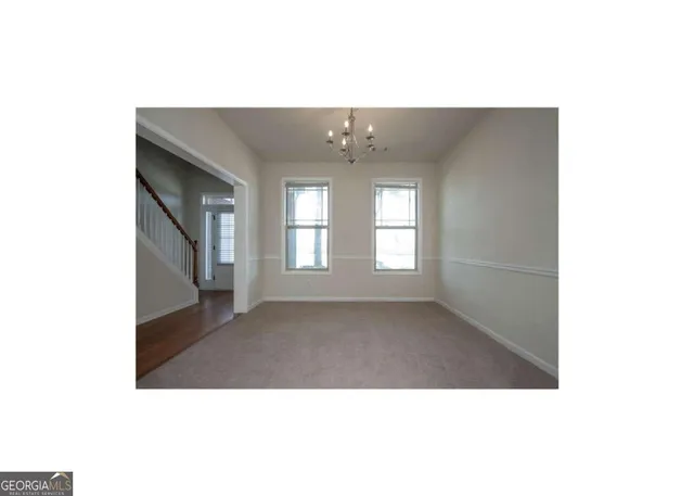 a upper view of a big room with windows and chandelier