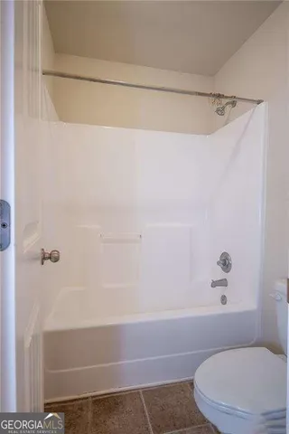 a bathroom with a shower and a toilet