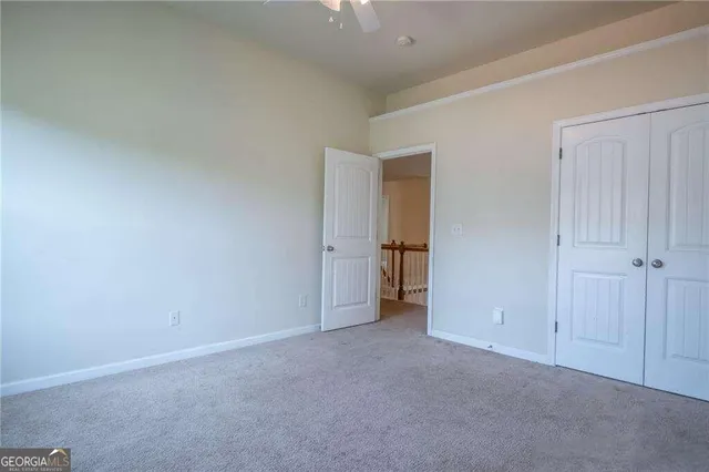 a view of an empty room and a bathroom