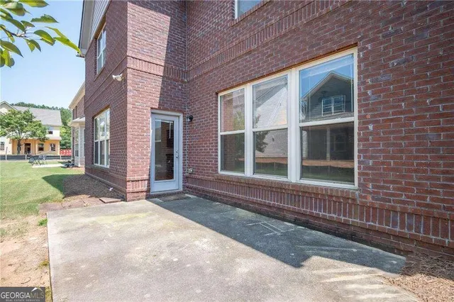 a view of a brick house with a yard