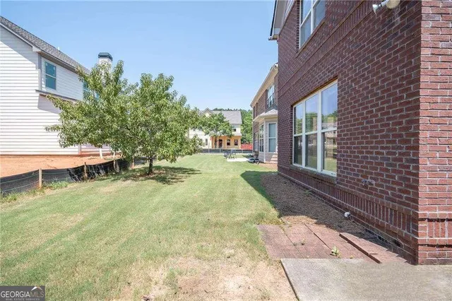 a view of yard with patio