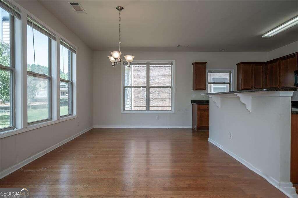 304 Ridge Pointe Drive Athens, GA 30606 - Photo 10 of 50 a view of an empty room with wooden floor and a window