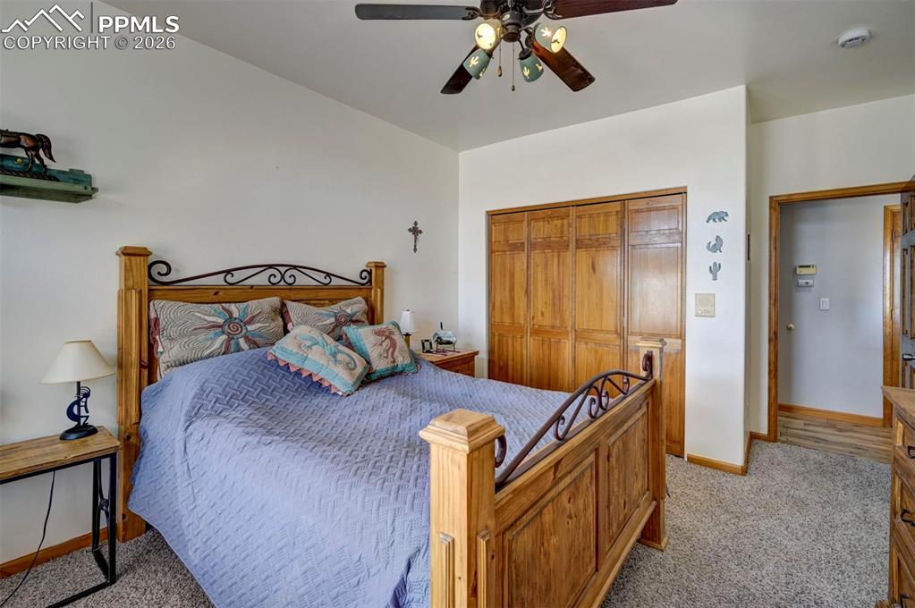 5910 McCart Ranch Circle Elizabeth, CO 80107 - Photo 17 of 50 a bedroom with a bed and wooden floor