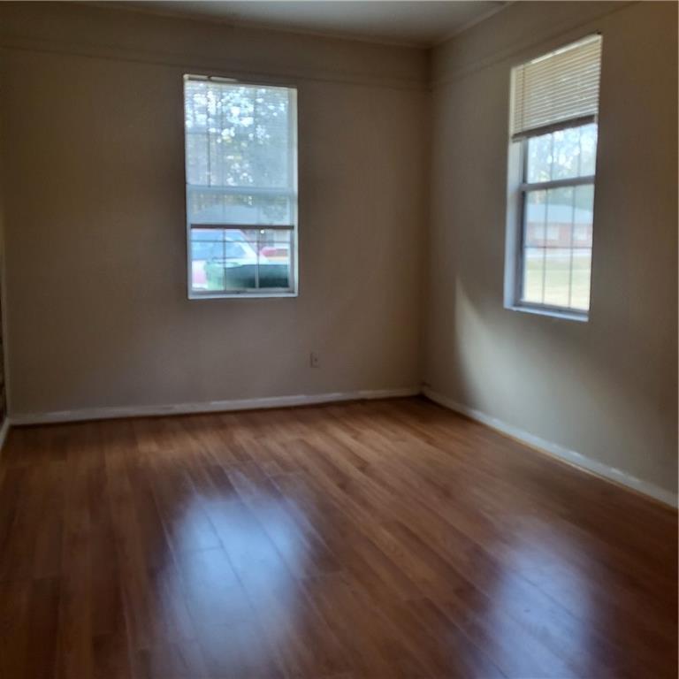 592 Allgood Road Stone Mountain, GA 30083 - Photo 6 of 14 an empty room with wooden floor and windows