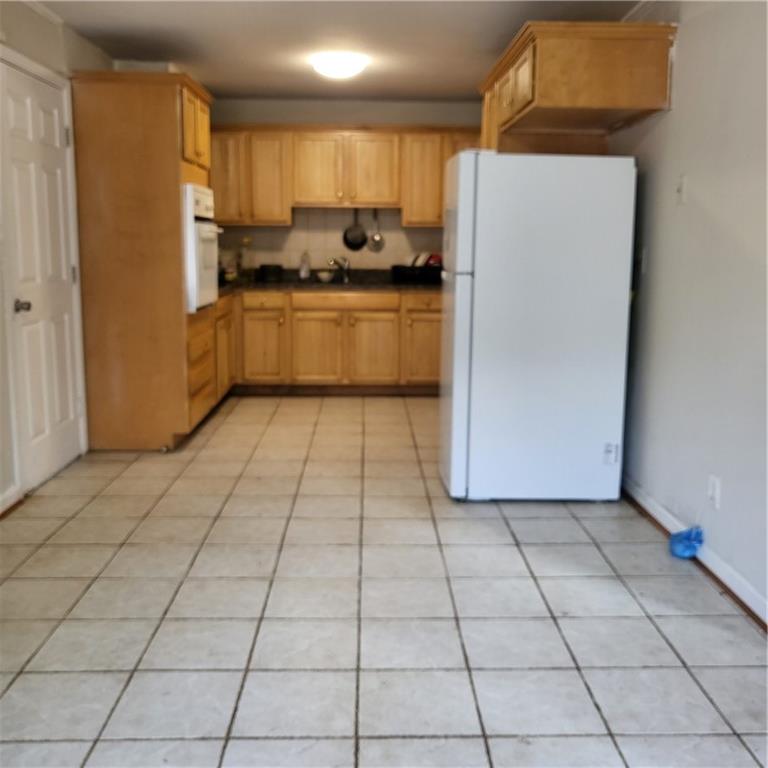592 Allgood Road Stone Mountain, GA 30083 - Photo 7 of 14 a kitchen with stainless steel appliances a refrigerator sink and cabinets