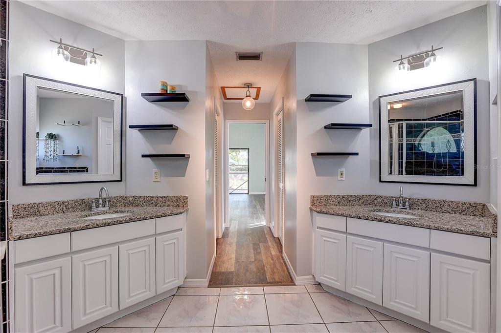1418 Buckner Road Valrico, FL 33596 - Photo 14 of 37 a spacious bathroom with a granite countertop sink and mirror