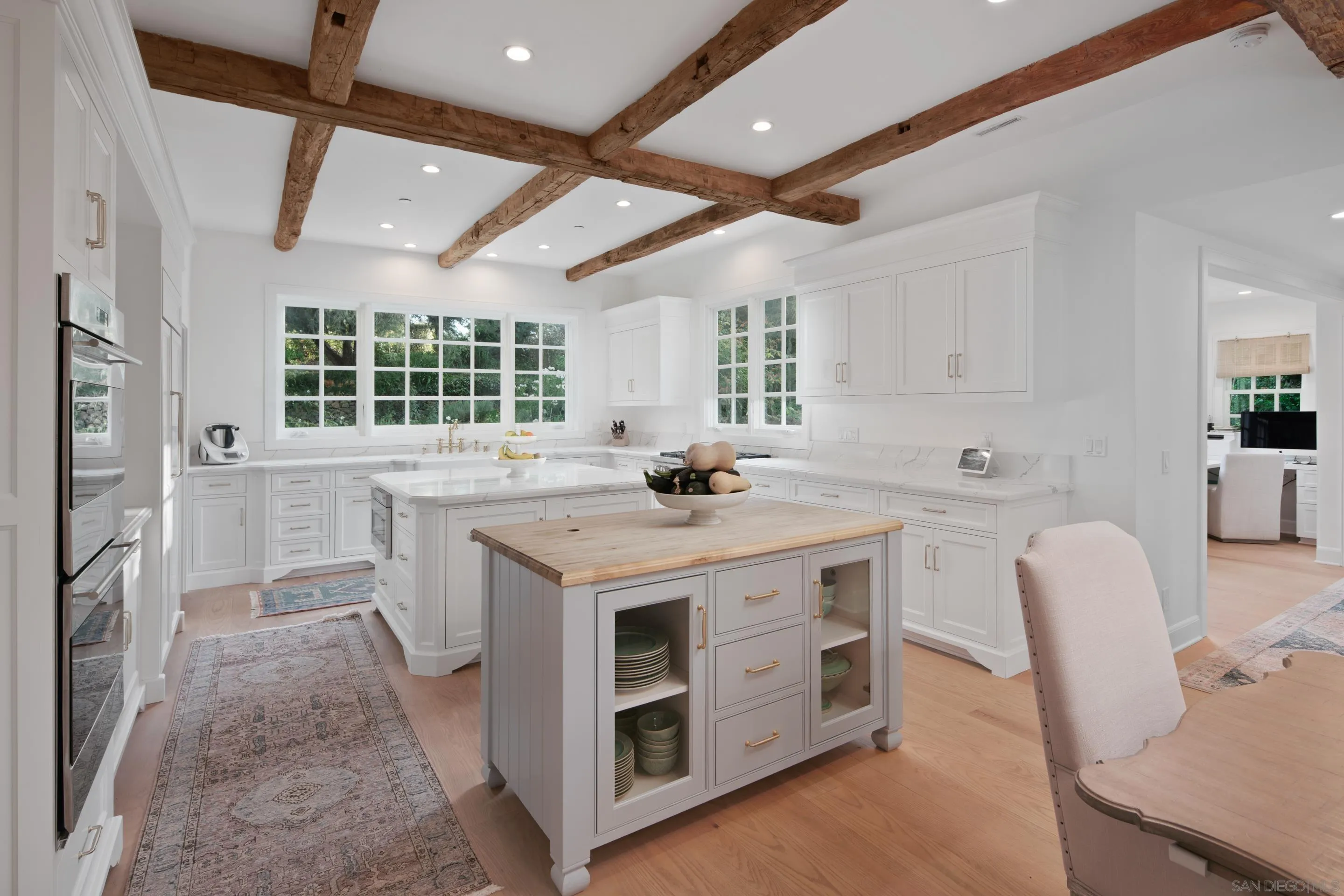 6502 Via Vista Canada Rancho Santa Fe, CA 92067 - Photo 13 of 55 a kitchen with a stove a sink a dining table and chairs