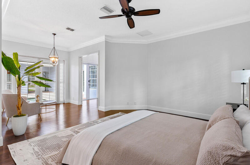 1710 Southwest 2nd Avenue Boca Raton, FL 33432 - Photo 14 of 29 a bedroom with a bed a chandelier and wooden floor