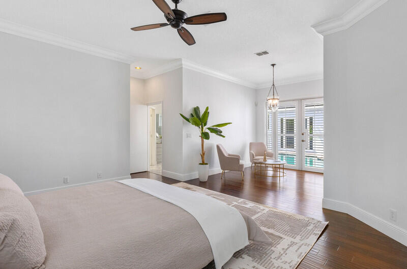 1710 Southwest 2nd Avenue Boca Raton, FL 33432 - Photo 15 of 29 a bedroom with a bed chandelier and wooden floor