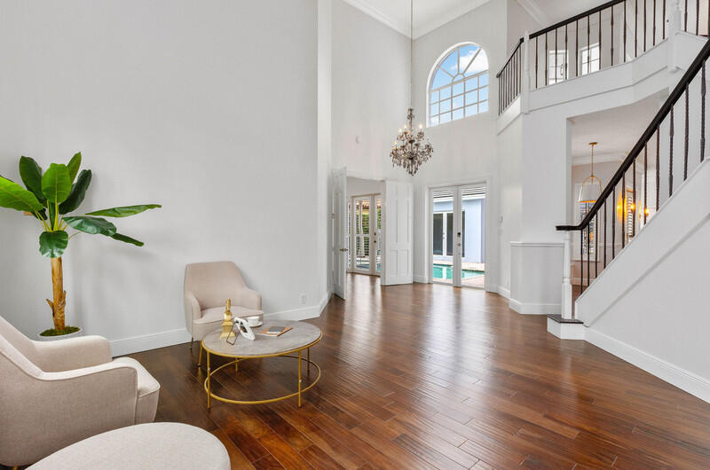 1710 Southwest 2nd Avenue Boca Raton, FL 33432 - Photo 22 of 29 a living room with furniture a chandelier and wooden floor