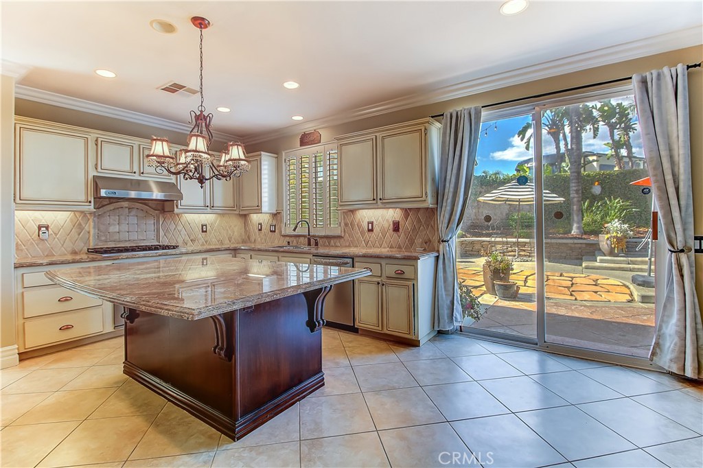 14182 Crystal View Terrace Riverside, CA 92508 - Photo 20 of 74 a kitchen with stainless steel appliances granite countertop a stove a sink and a refrigerator