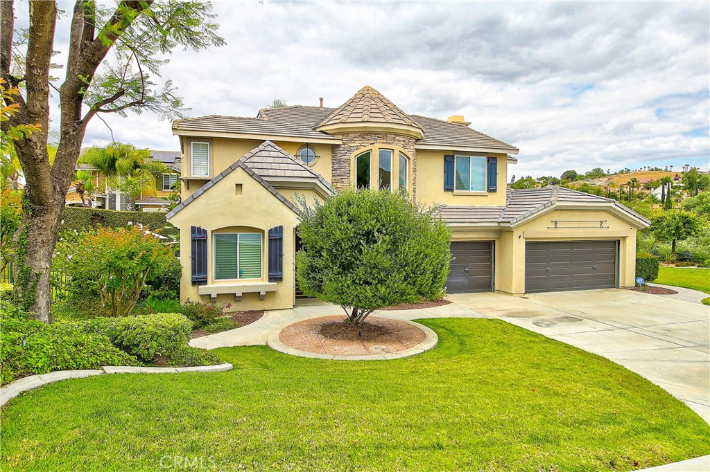 14182 Crystal View Terrace Riverside, CA 92508 - Photo 2 of 74 a front view of a house with a yard and garage