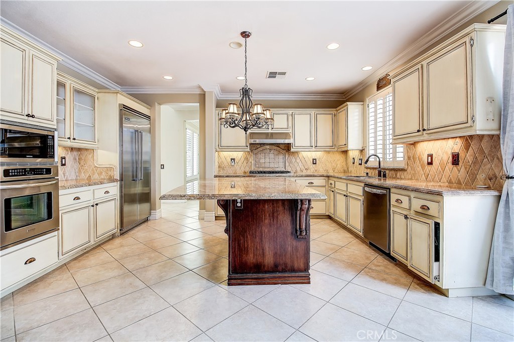 14182 Crystal View Terrace Riverside, CA 92508 - Photo 23 of 74 a kitchen with stainless steel appliances granite countertop a stove a sink and a refrigerator