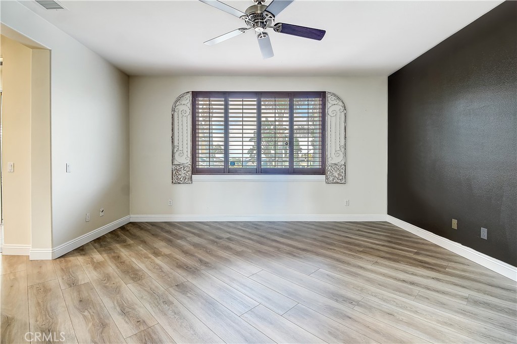 14182 Crystal View Terrace Riverside, CA 92508 - Photo 42 of 74 a view of an empty room with wooden floor and a window