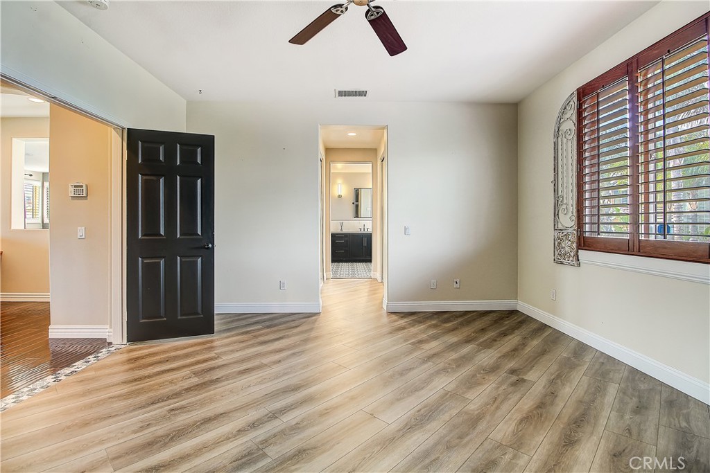 14182 Crystal View Terrace Riverside, CA 92508 - Photo 45 of 74 a view of an empty room with wooden floor and a window