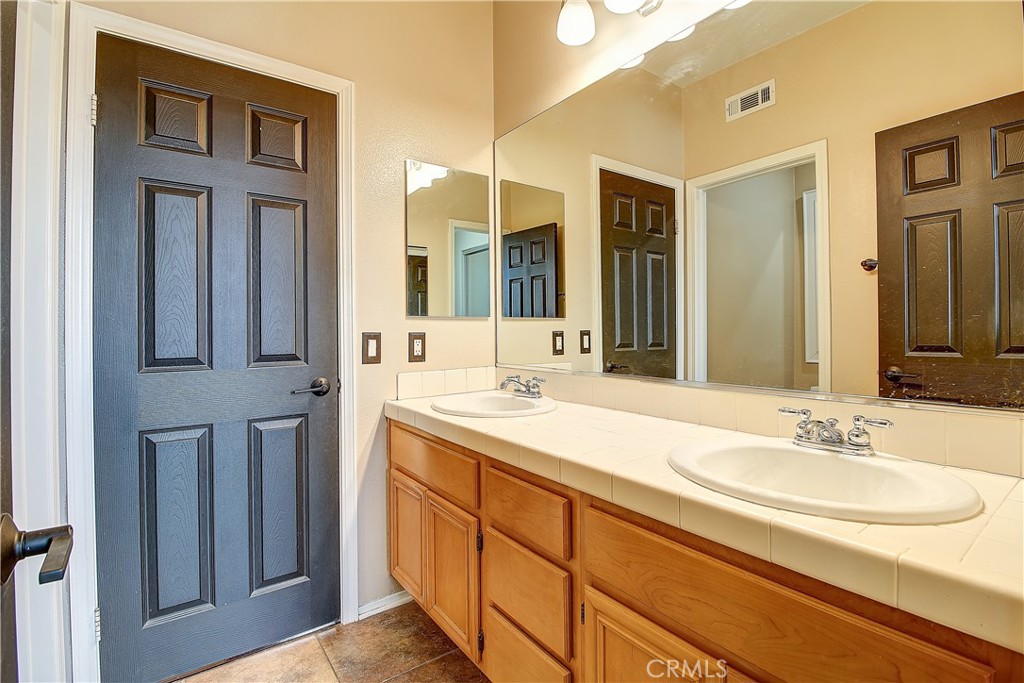 14182 Crystal View Terrace Riverside, CA 92508 - Photo 58 of 74 a bathroom with a sink double vanity and a mirror