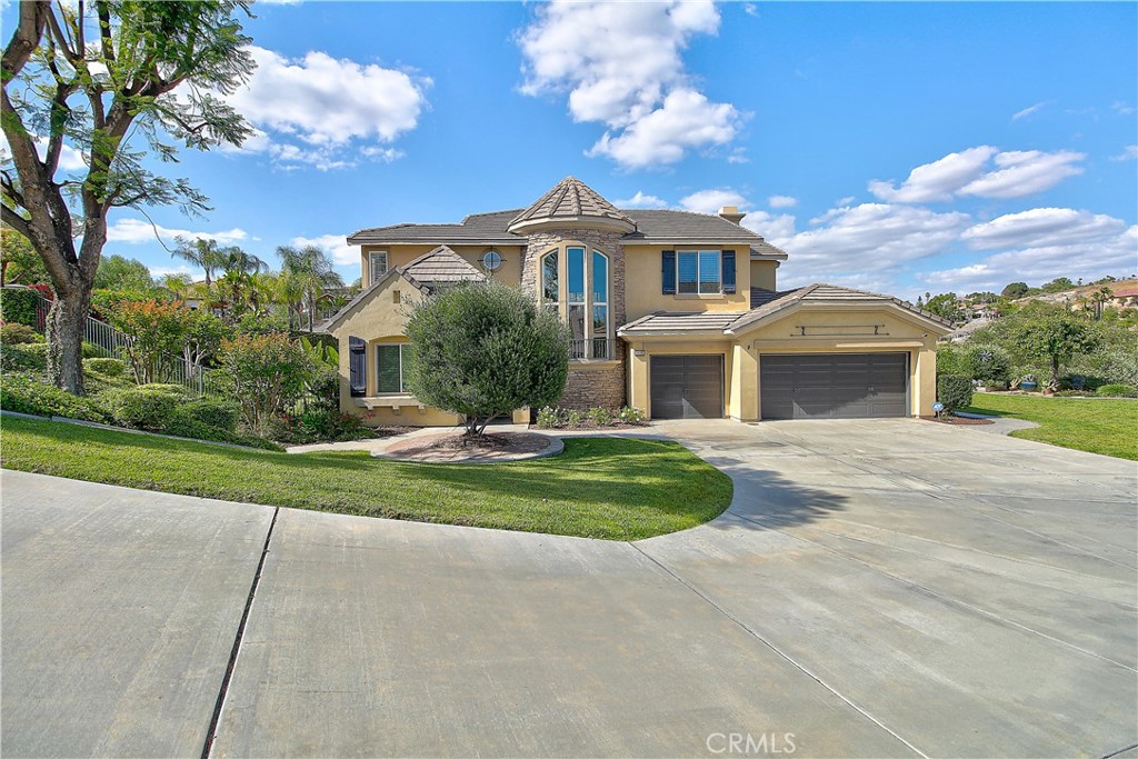 14182 Crystal View Terrace Riverside, CA 92508 - Photo 6 of 74 a front view of a house with a yard and garage