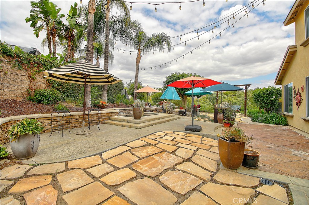 14182 Crystal View Terrace Riverside, CA 92508 - Photo 68 of 74 a view of a patio with a table and chairs under an umbrella